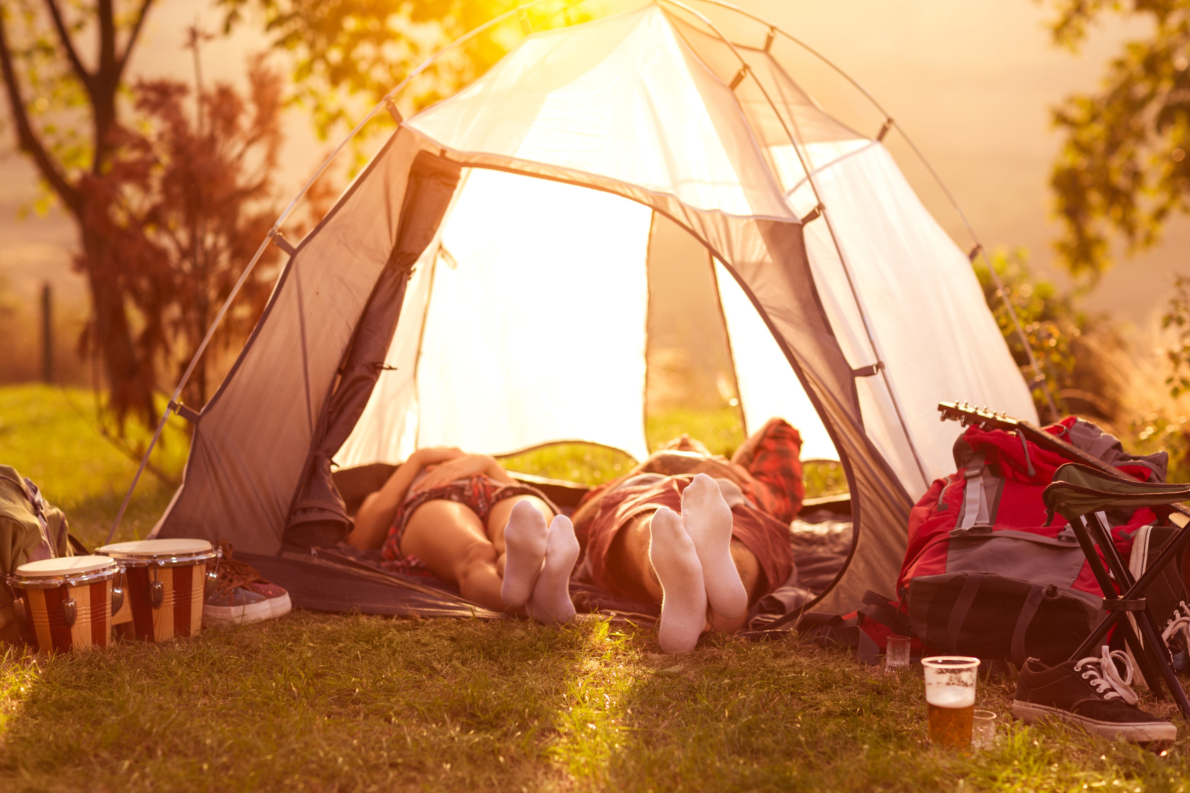 Two people laying down in a tent