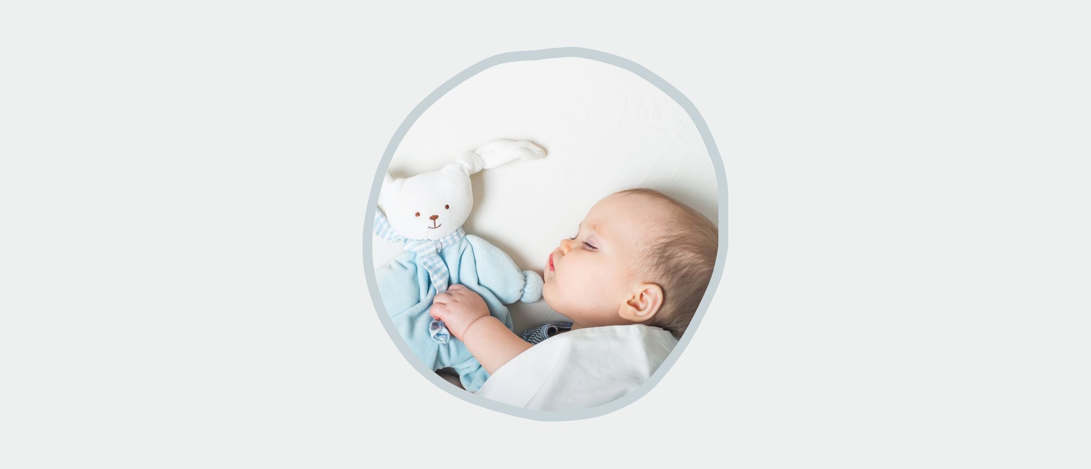 baby sleeping on side with his stuffed animal