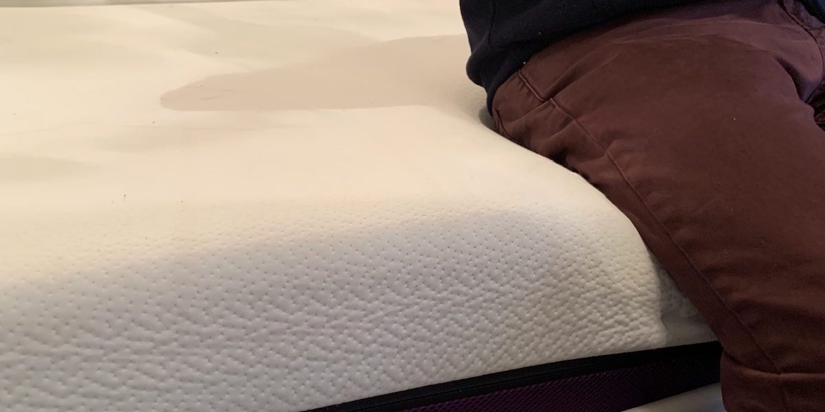 Man Sitting on Polysleep Foam Mattress