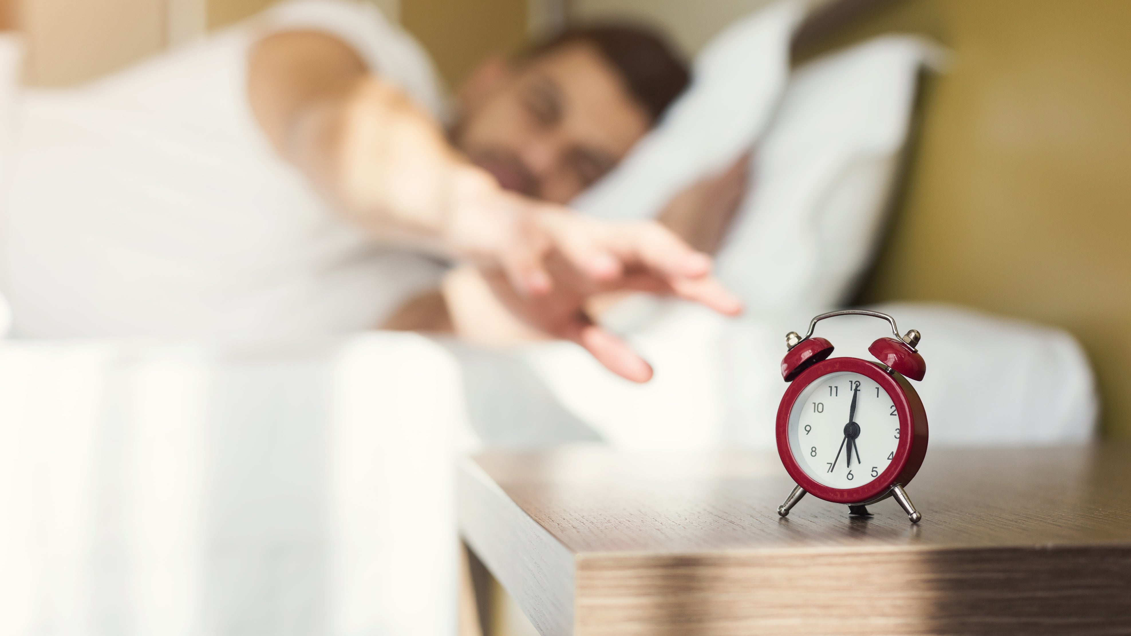 Sleepy guy wakes up early after alarm signal