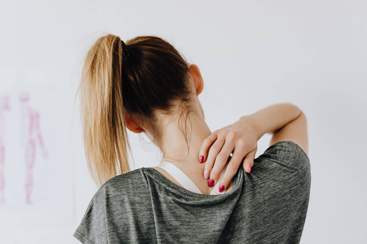 Woman having neck pain upon waking up.