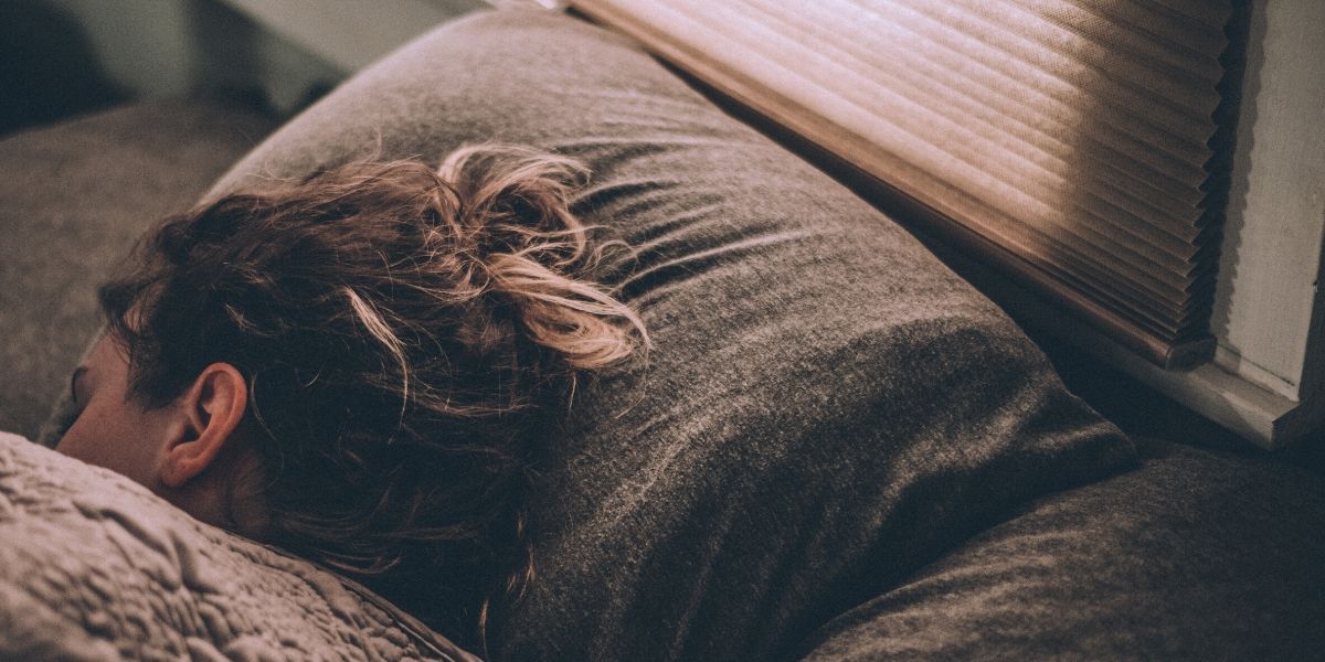 Woman asleep with her head resting on a pillow