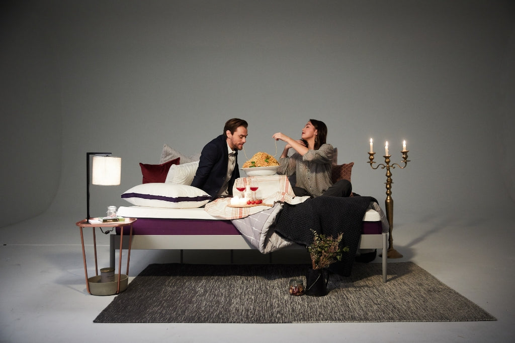 Couple eating on their bed for Valentine's Day